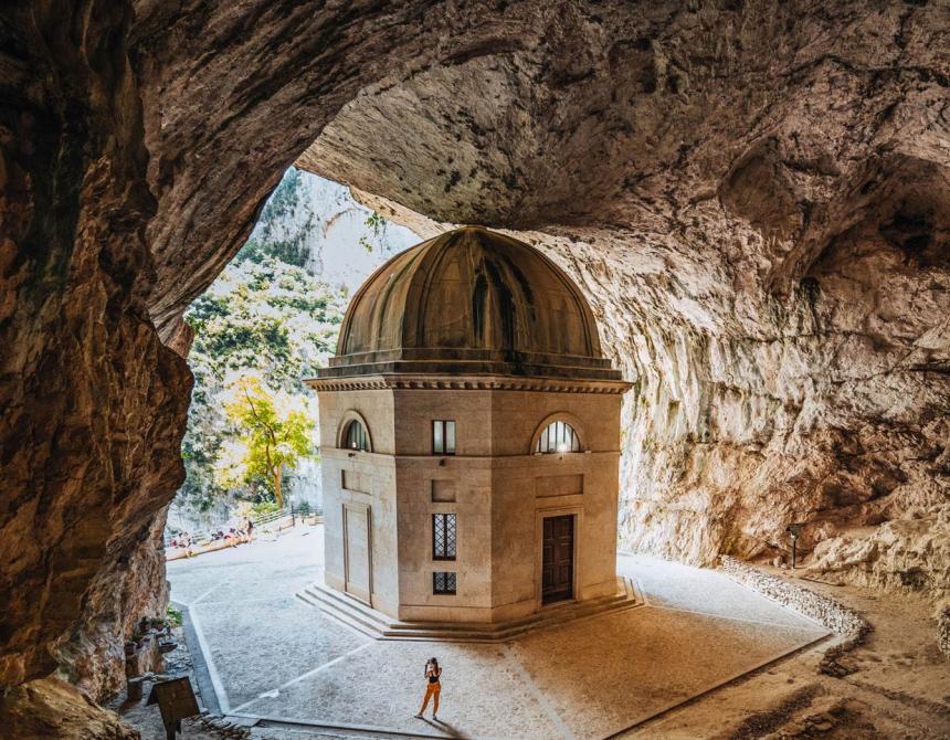 Historic building with dome, located inside a large cave.